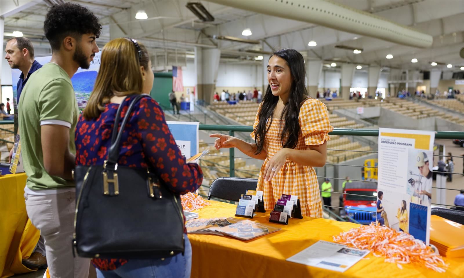 A college representative talks to a family